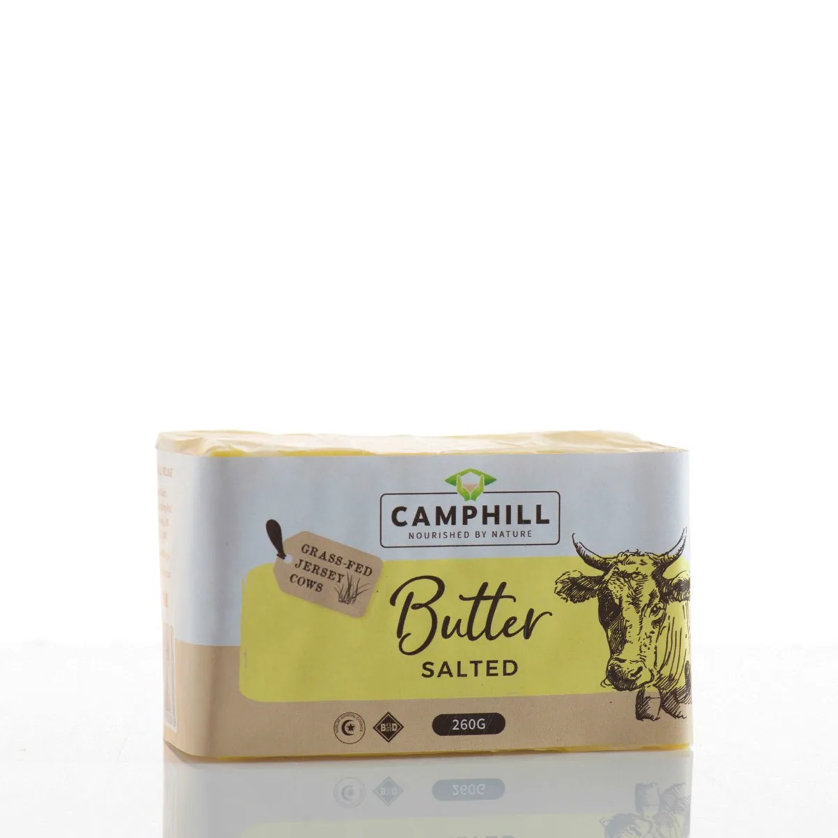 A 260 g block of Camphill salted butter wrapped in paper with a yellow label and a drawing of a Jersey cow.