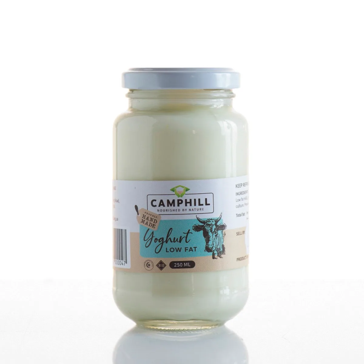 Glass jar of Camphill low fat yoghurt with a cow illustration on the label