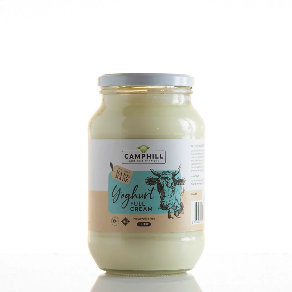 A glass jar of Camphill full cream yoghurt with its hand-drawn cow label